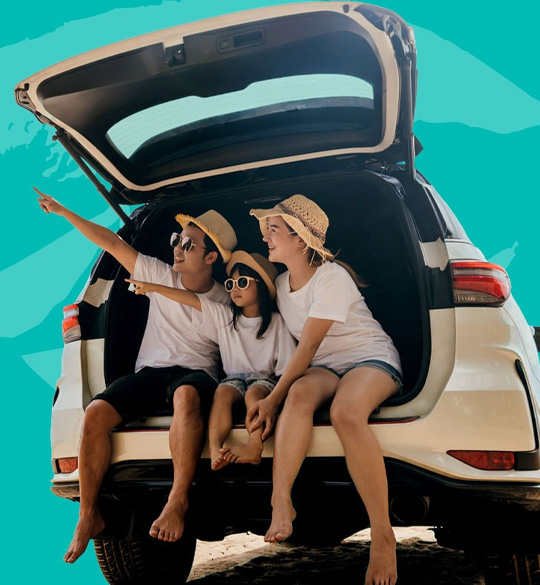 A family enjoying time together beside their car